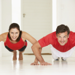 Couple doing push-ups in home gym